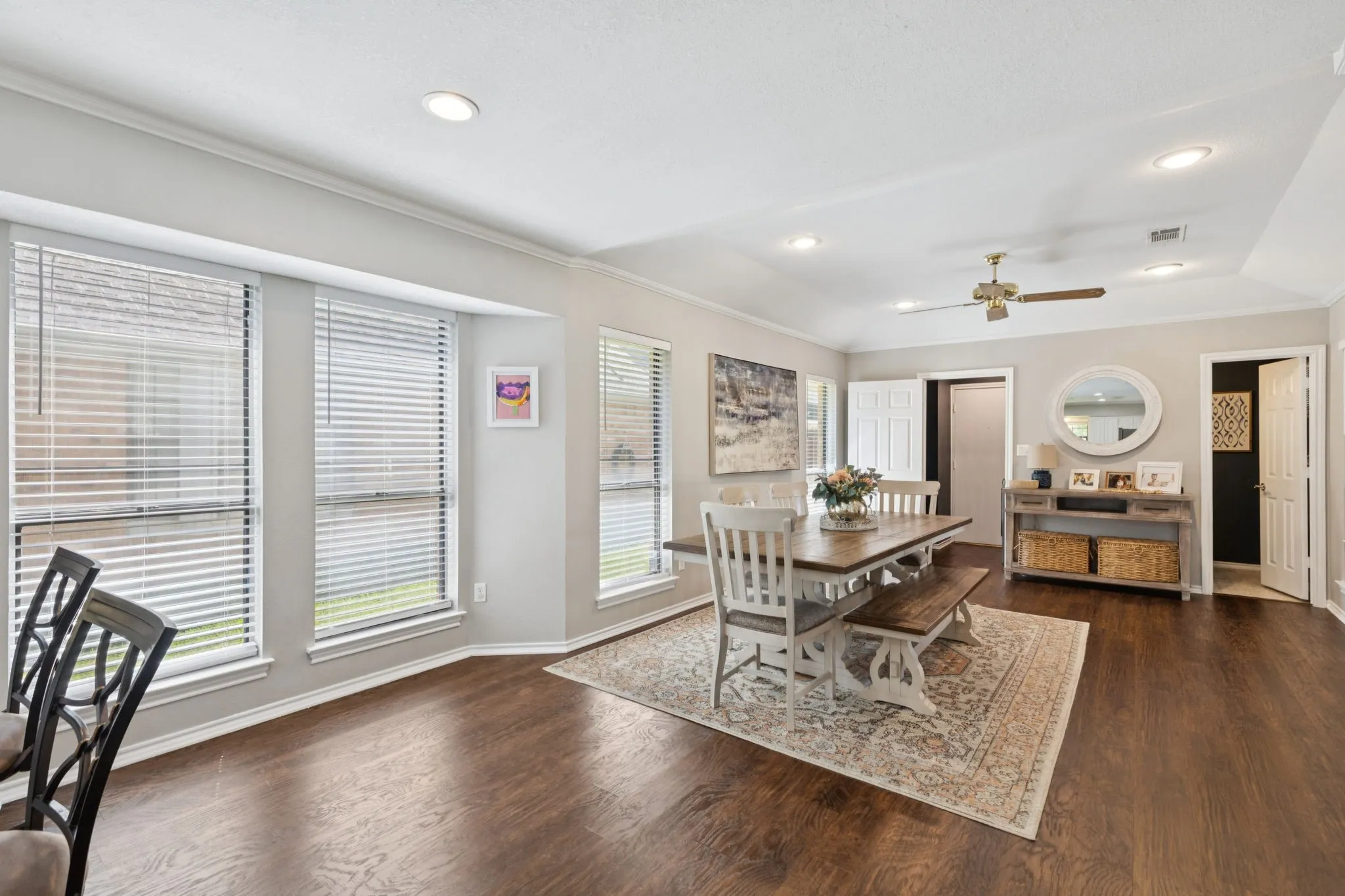 Wood-finish flooring throughout, recessed lighting, and a ceiling fan
