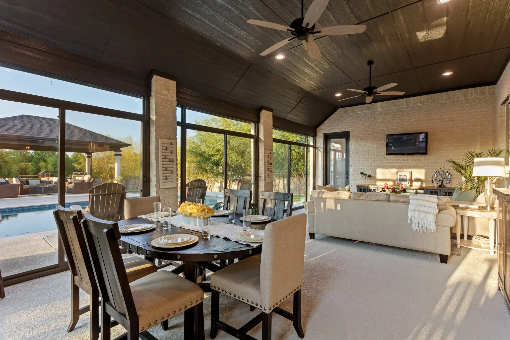 Outside, the experience becomes extraordinary. The 2024 saltwater pool & pergola overlook a peaceful park-like panoramic backdrop, while the covered patio, extended wraparound porch & approximately 527-square-foot enclosed three-season patio create an exceptional private setting for entertaining, dining & enjoying every season. Climate-controlled shades & extensive landscaping, decorative lighting complete an outdoor environment that feels remarkably resort-like.