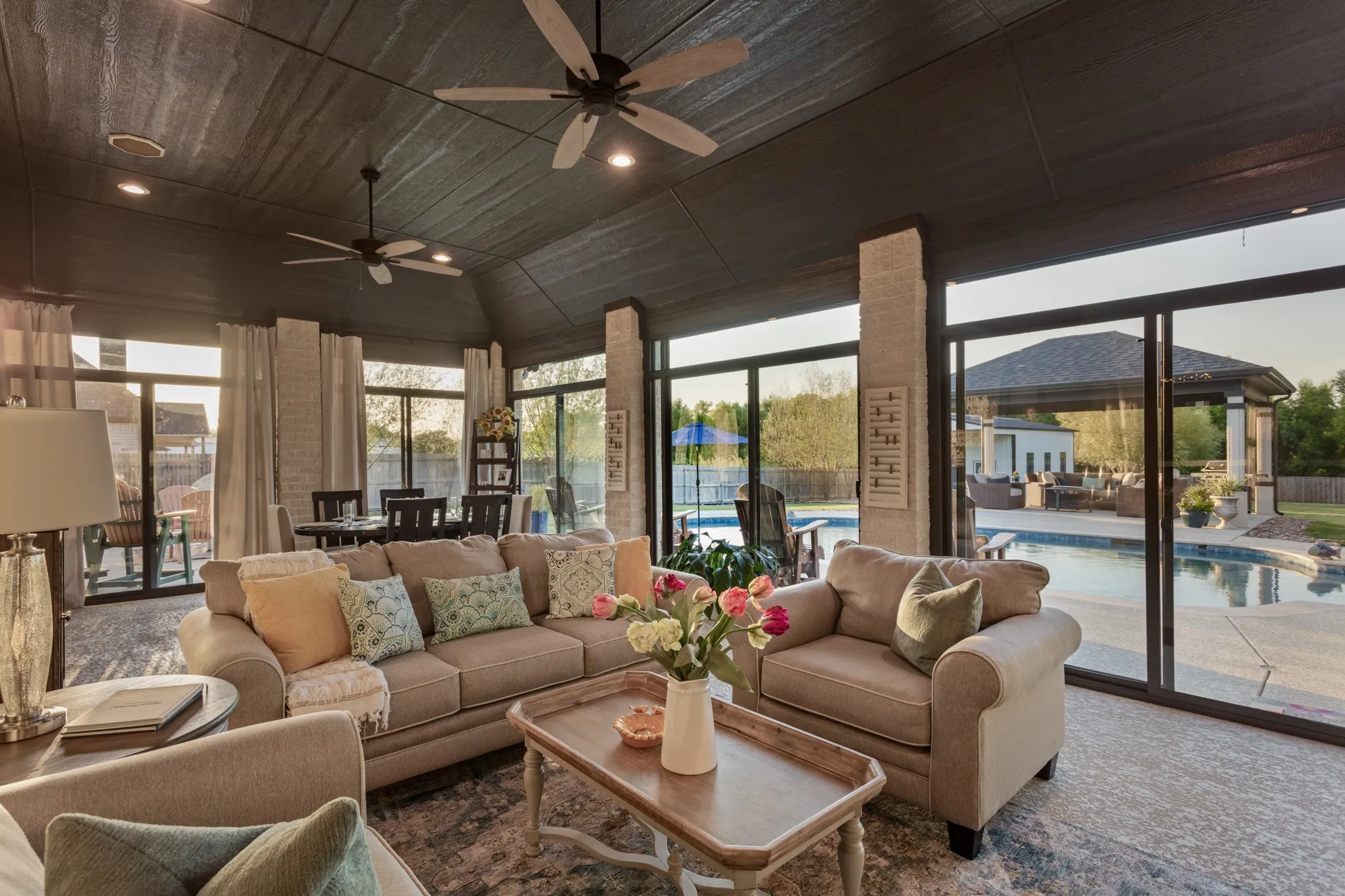 Outside, the experience becomes extraordinary. The 2024 saltwater pool & pergola overlook a peaceful park-like panoramic backdrop, while the covered patio, extended wraparound porch & approximately 527-square-foot enclosed three-season patio create an exceptional private setting for entertaining, dining & enjoying every season. Climate-controlled shades & extensive landscaping, decorative lighting complete an outdoor environment that feels remarkably resort-like.