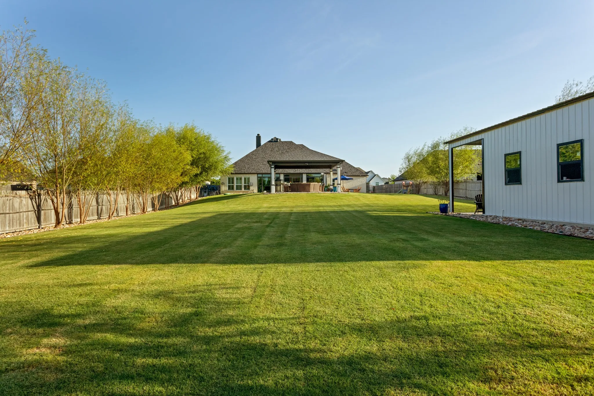 For those who appreciate exceptional utility as much as beauty, the property continues to impress with oversized 25+ foot garages, 10-foot ceilings, upgraded doors, abundant lighting, extensive storage & 50-amp power. A remarkable 20' x 40' x 12' electrified workshop, added in 2024, provides an extraordinary space for automotive pursuits, hobbies, projects, equipment or whatever inspires you. Recent improvements include vinyl windows, 2023 interior paint, privacy fencing, pool & pergola, 2024 workshop, 2025 enclosed patio, plantation shutters, climate-controlled shades & custom garage flooring, plus 2026 kitchen & gate enhancements. Whole-home filtration, UV purification, reverse osmosis, Rinnai tankless water heating, zoned HVAC, smart-home technology, whole-home networking & extensive attic storage further elevate the property.