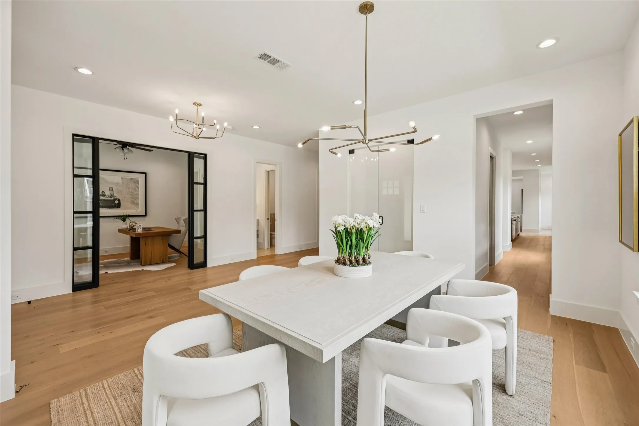 Hardwood flooring, recessed lighting, modern chandelier, double glass-paneled doors, contemporary light fixture