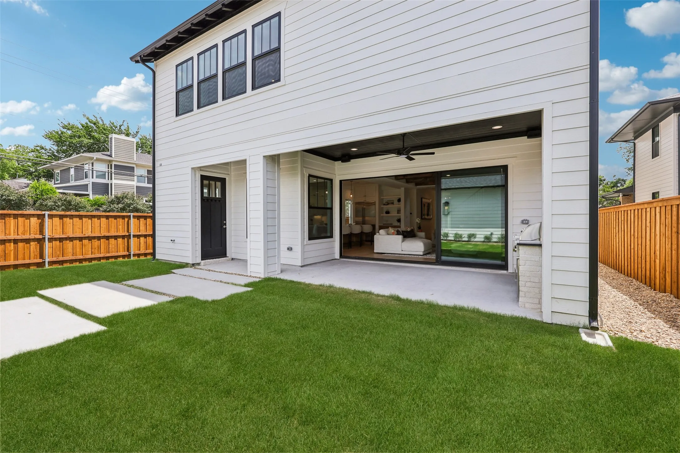 White siding exterior with black trim windows