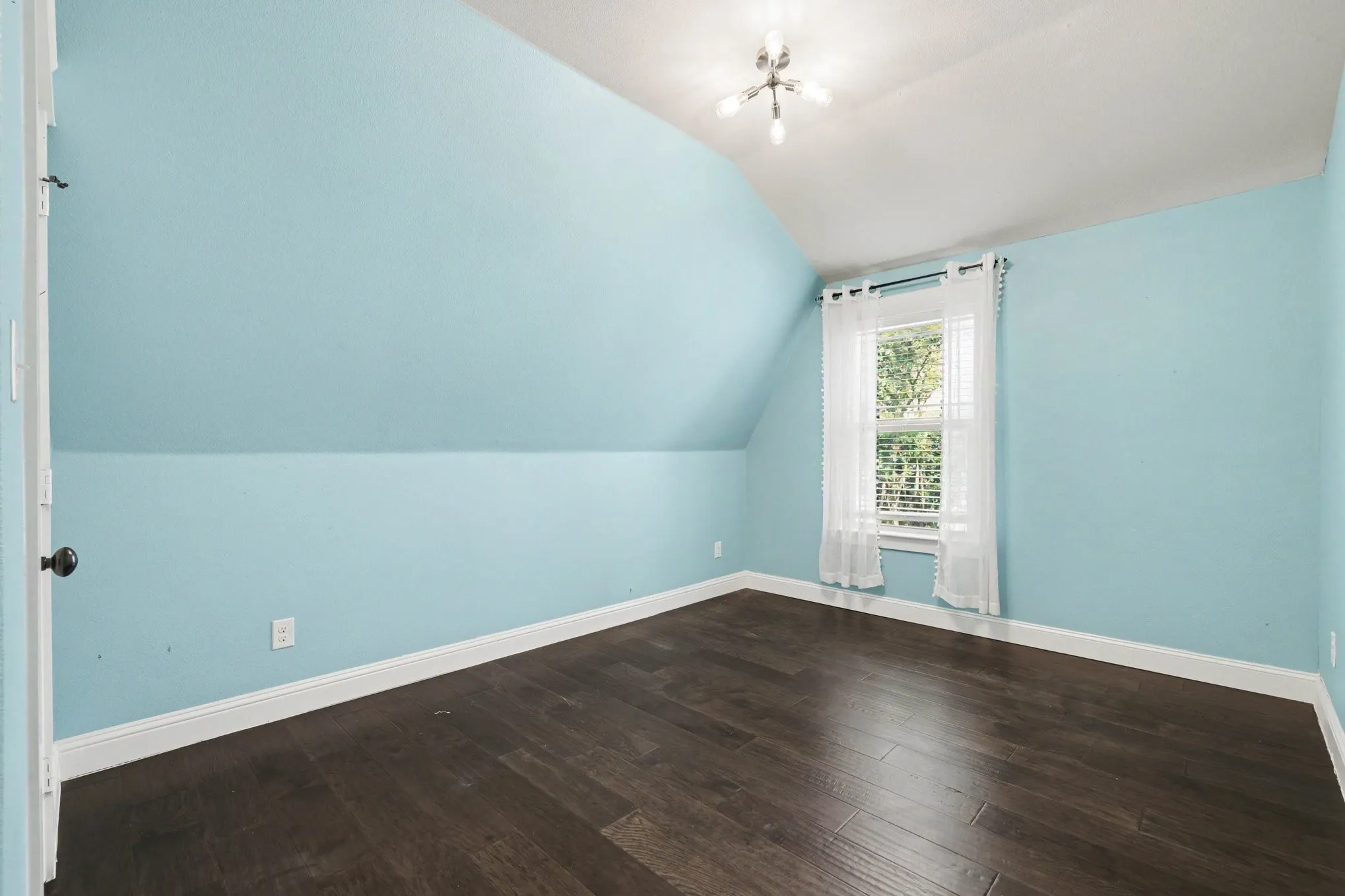 Dark wood-finish flooring with white trim