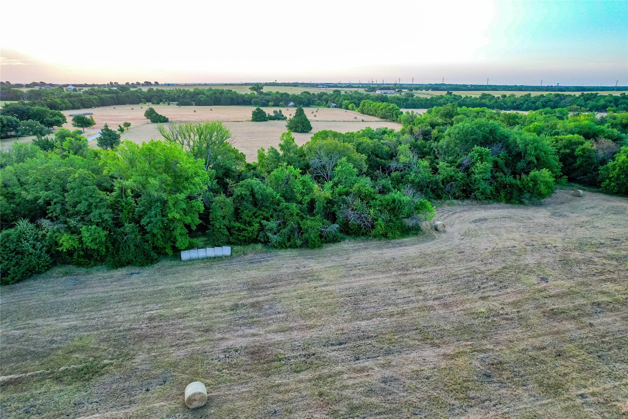 Expansive parcel featuring mature trees and open fields