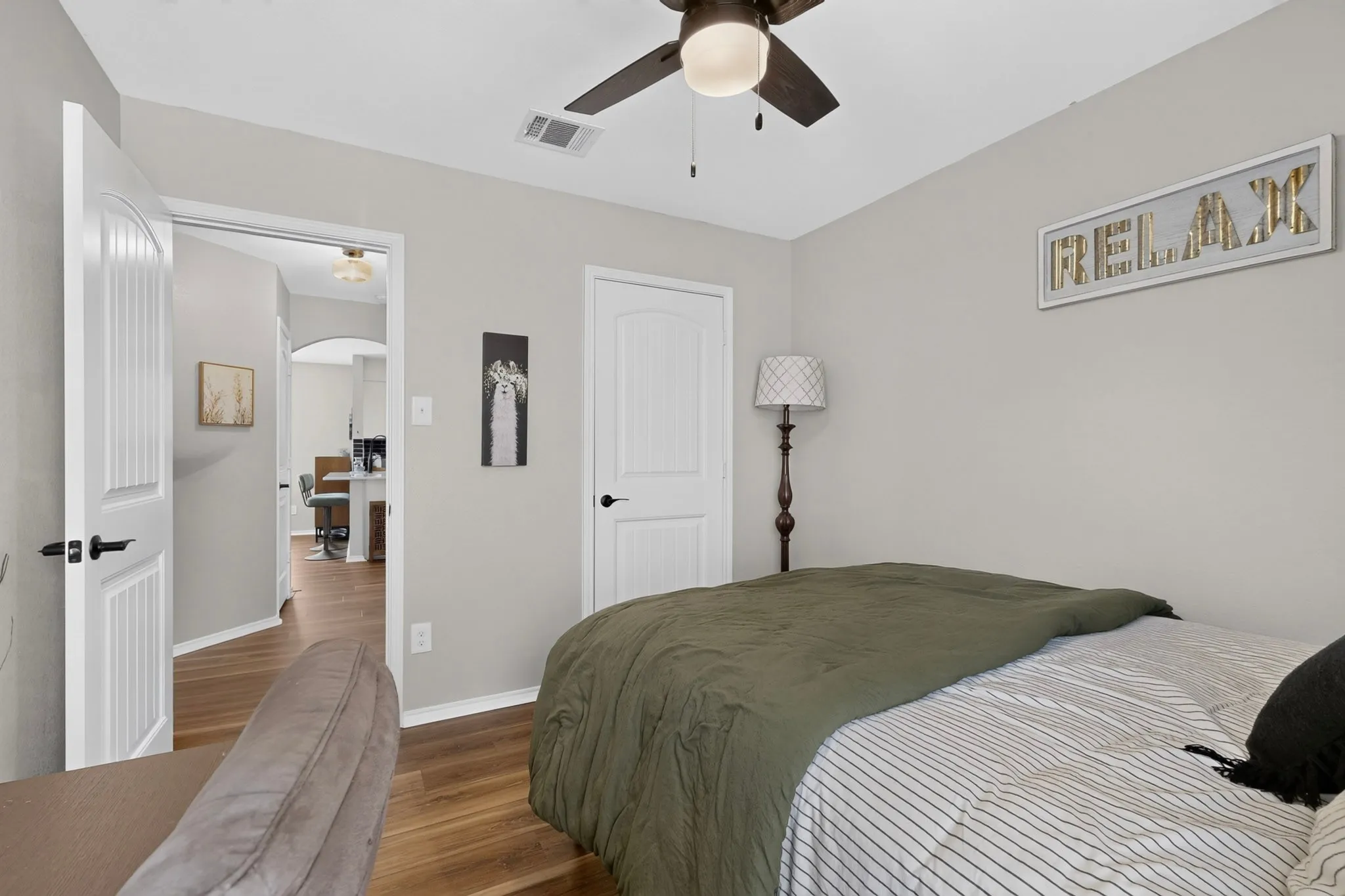 Wood-finish flooring throughout, complemented by a ceiling fan with integrated lighting