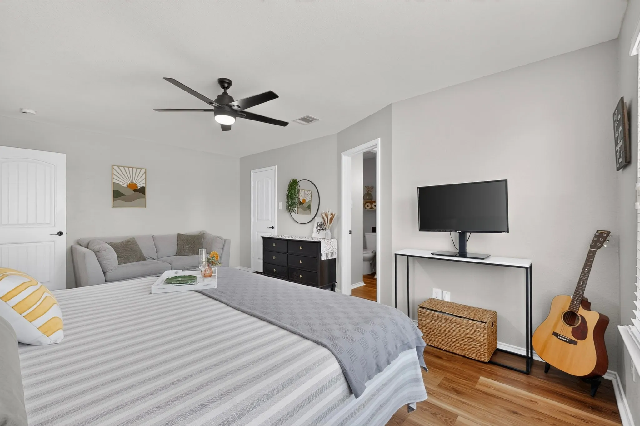 Recessed lighting, wood-finish flooring, ceiling fan with integrated lighting, white paneled doors, and an en-suite bathroom