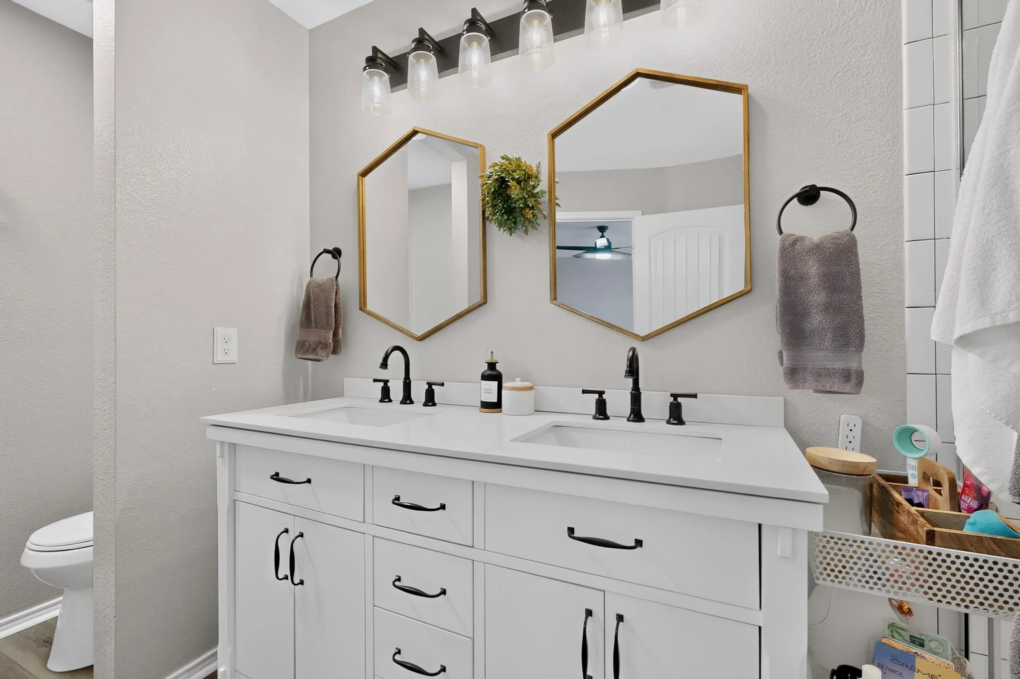 Dual hexagonal mirrors with gold-tone frames