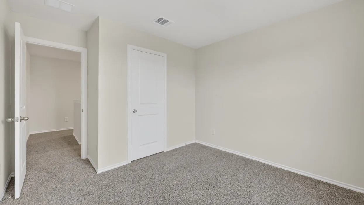 Neutral wall color, gray carpet flooring, white trim, and white paneled doors