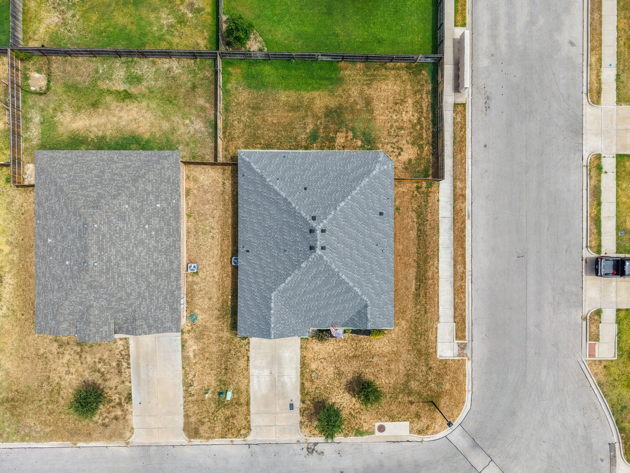 Gabled roofline, concrete driveway, concrete sidewalk, fenced backyard, street access