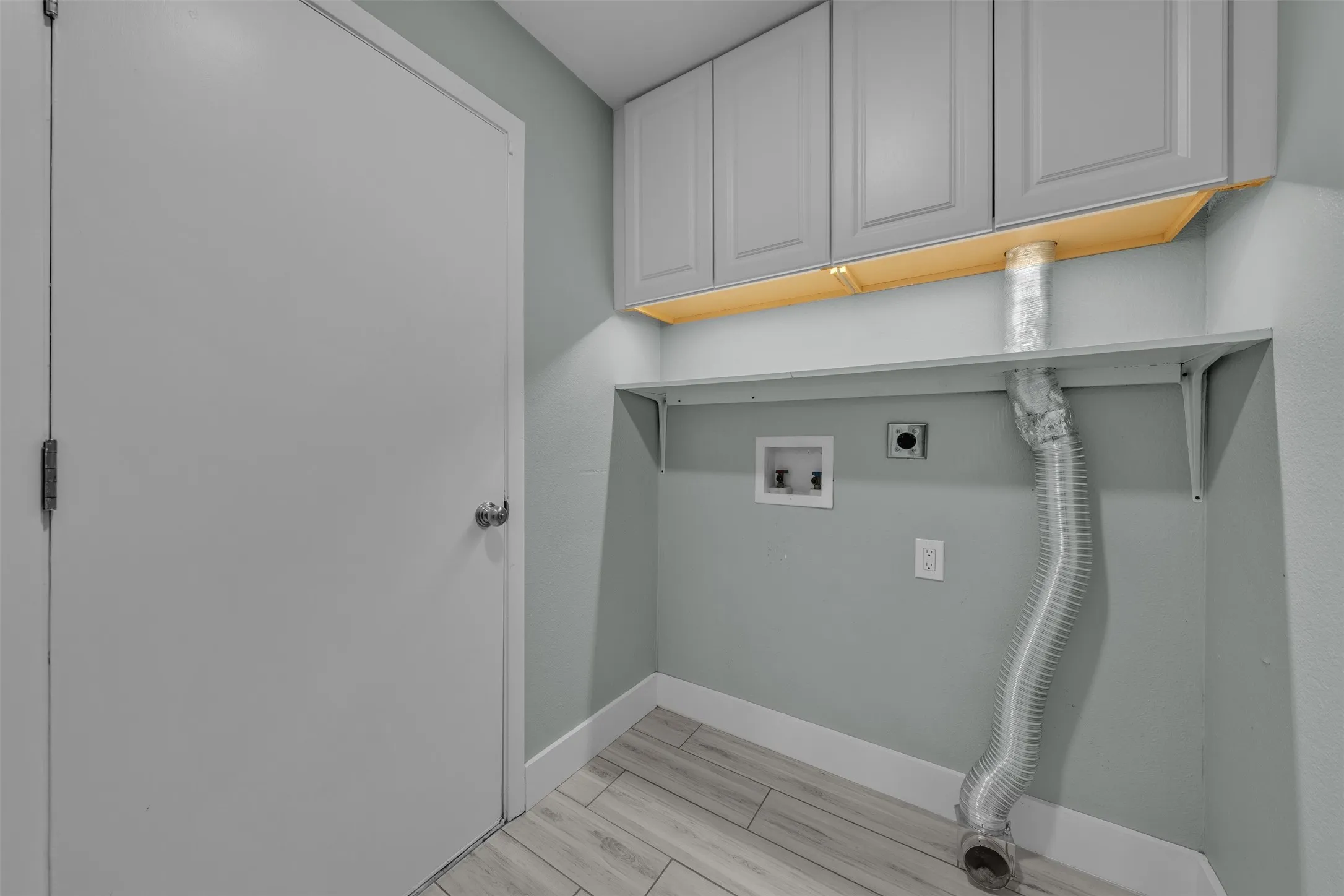 Separate utility opens to hall and garage has cabinets