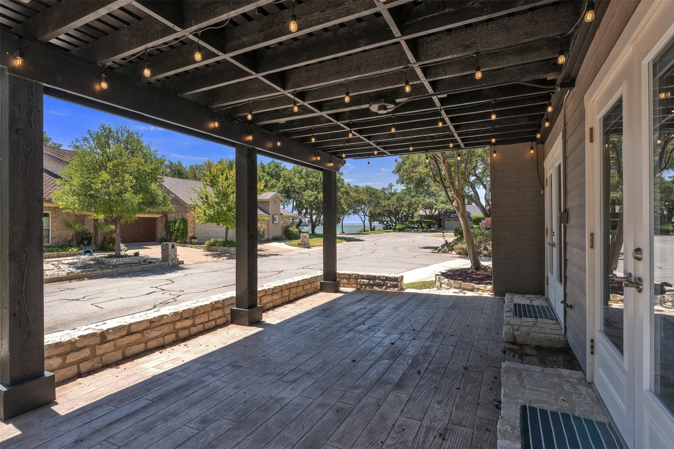 Oversized covered pergola, stamped concrete with lighting and two sets of French doors