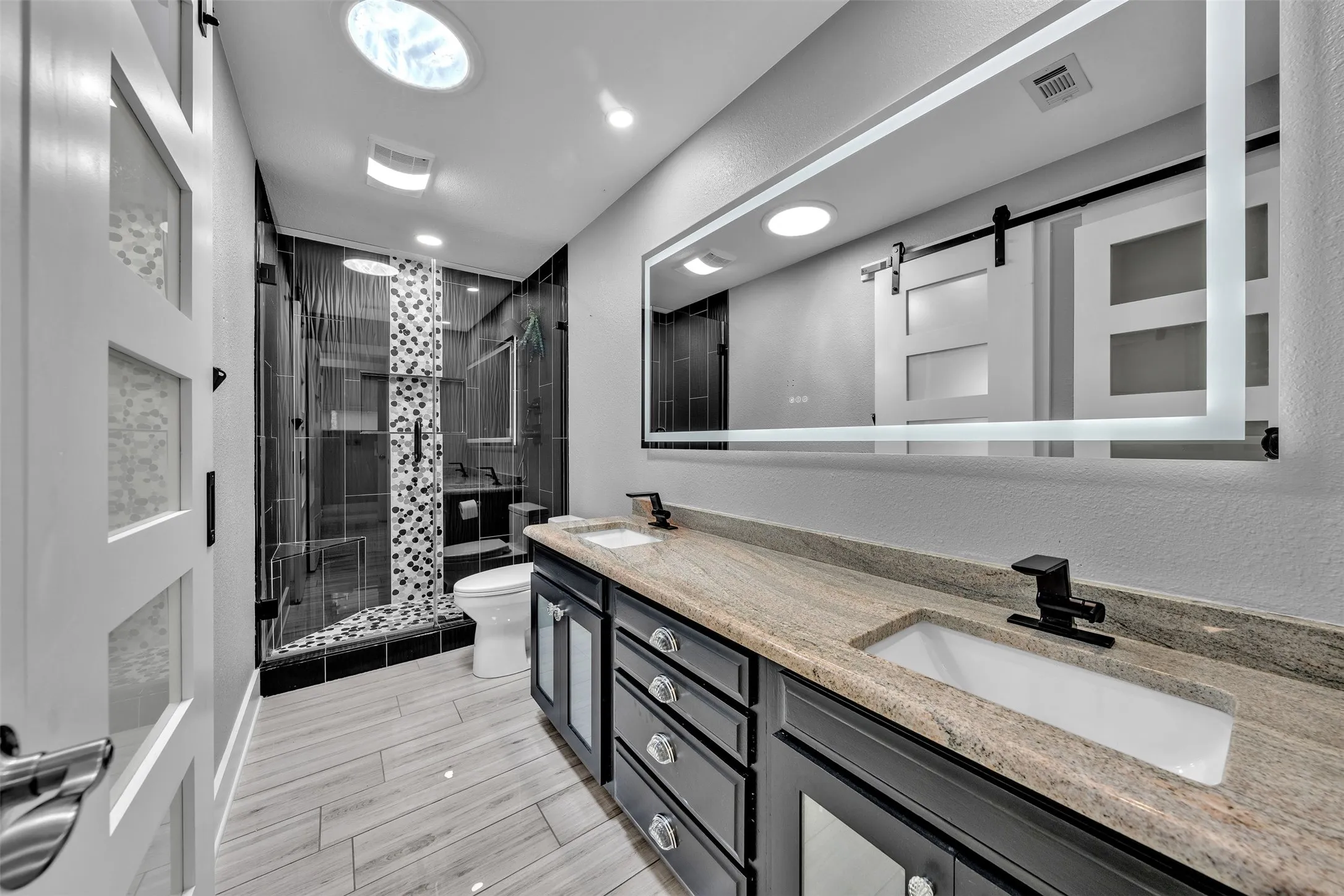Hall bath also opens to third bedroom and recently upgraded with new tile and cabinetry