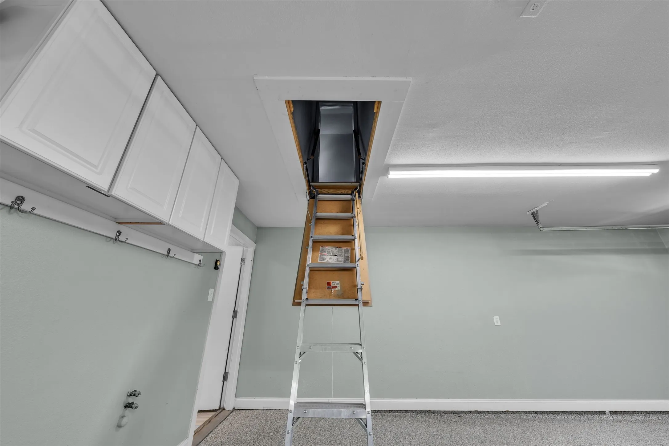 Flex area over garage has cabinets, flooring and air