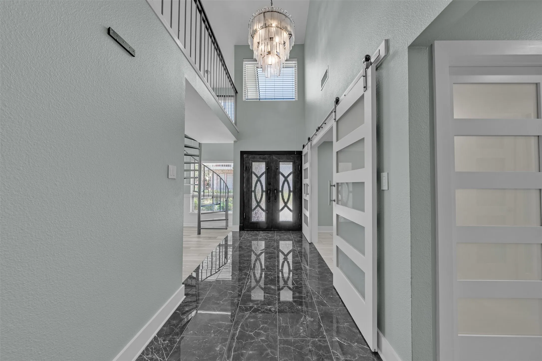 Beautiful doors, porcelain tile entry and barn doors to secondary bedroom used as office.