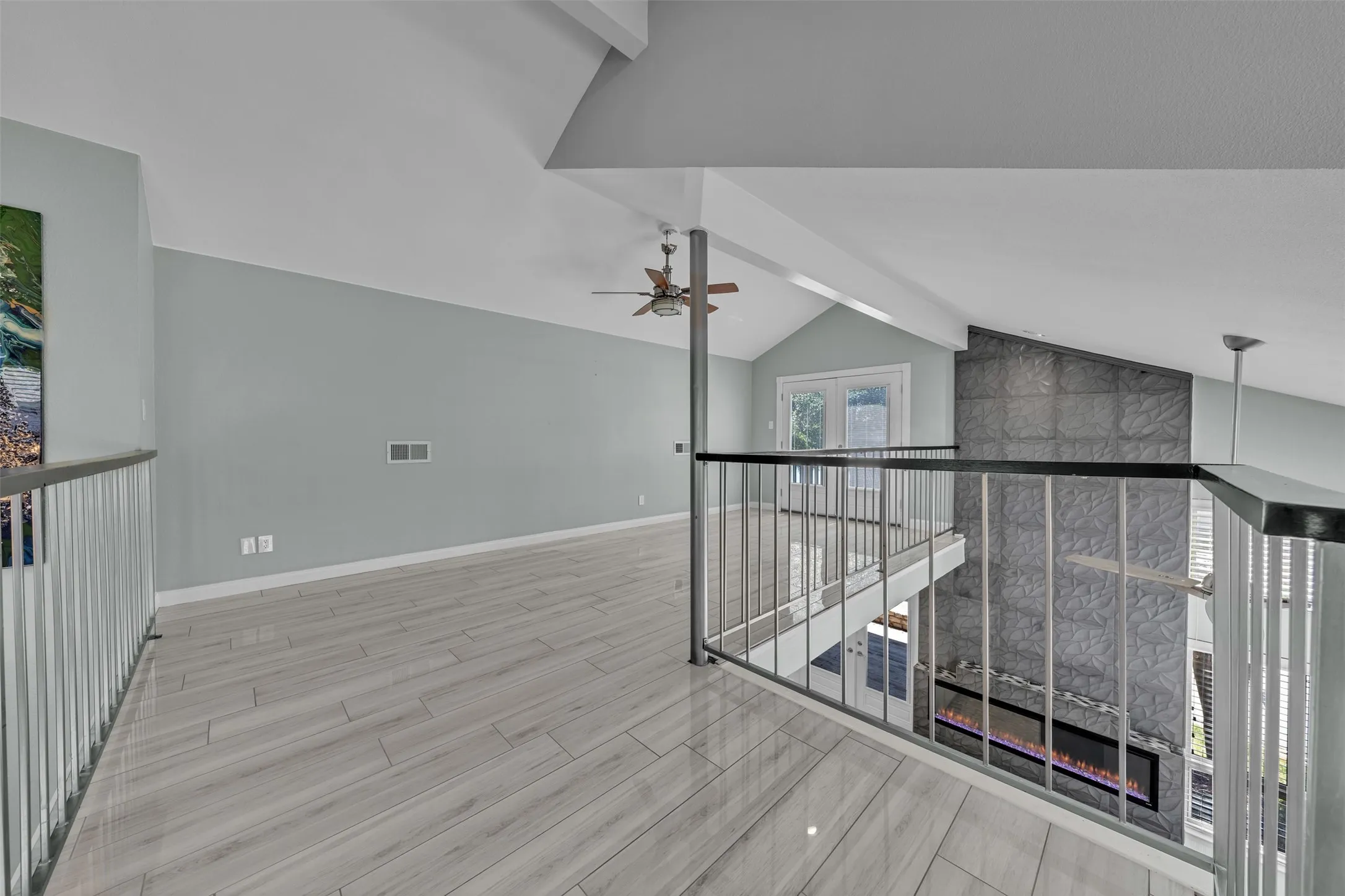 Opens to below with french doors to balcony