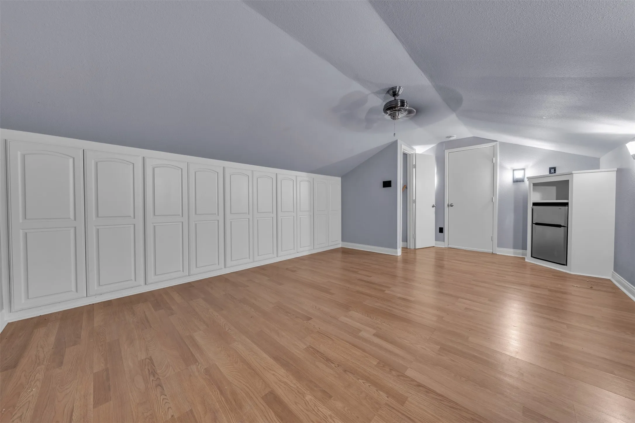 Wall of cabinets great flex space accessible through garage stairs