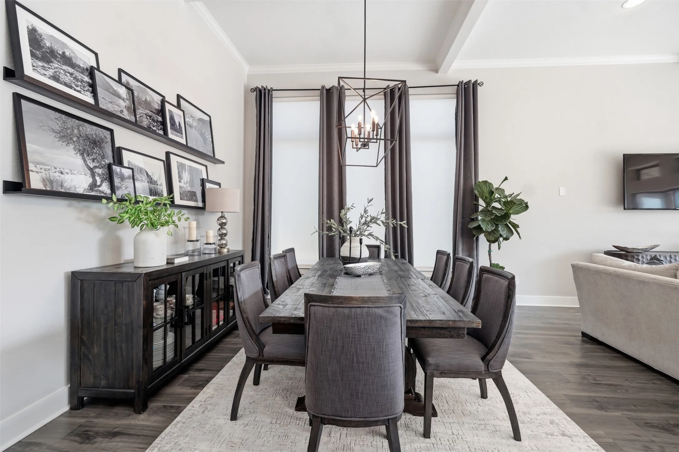 Formal dining area with coffered ceilings, wood-finish flooring, and a linear chandelier