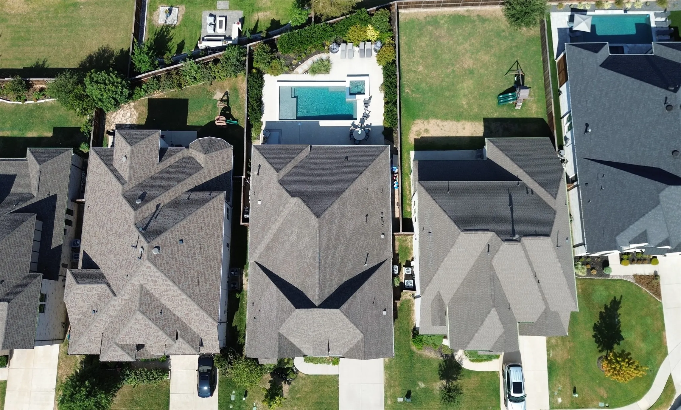 OVERSIZED LOT!! Expansive backyard featuring a rectangular swimming pool, integrated spa, and surrounding patio area