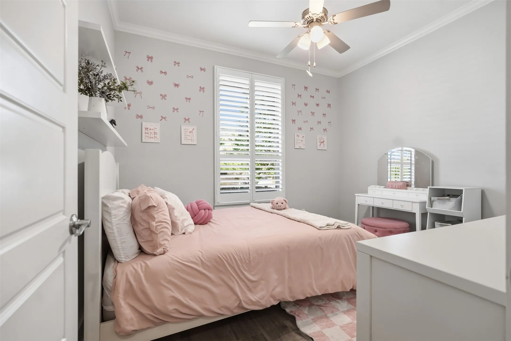 Bedroom 3 - Crown molding, wood-finish flooring, ceiling fan with light fixture, plantation shutters, and built-in shelving
