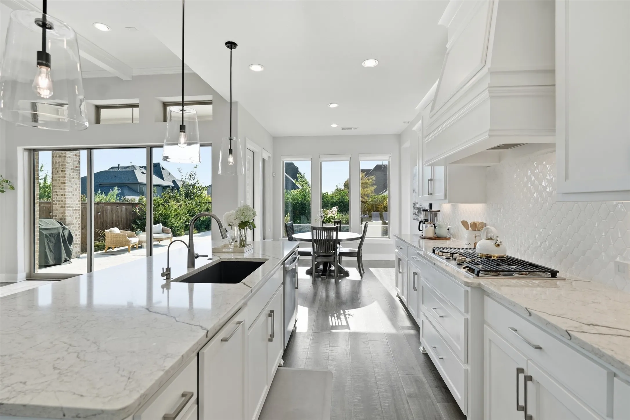 Spacious kitchen featuring white cabinetry, light-toned countertops, and a gas range