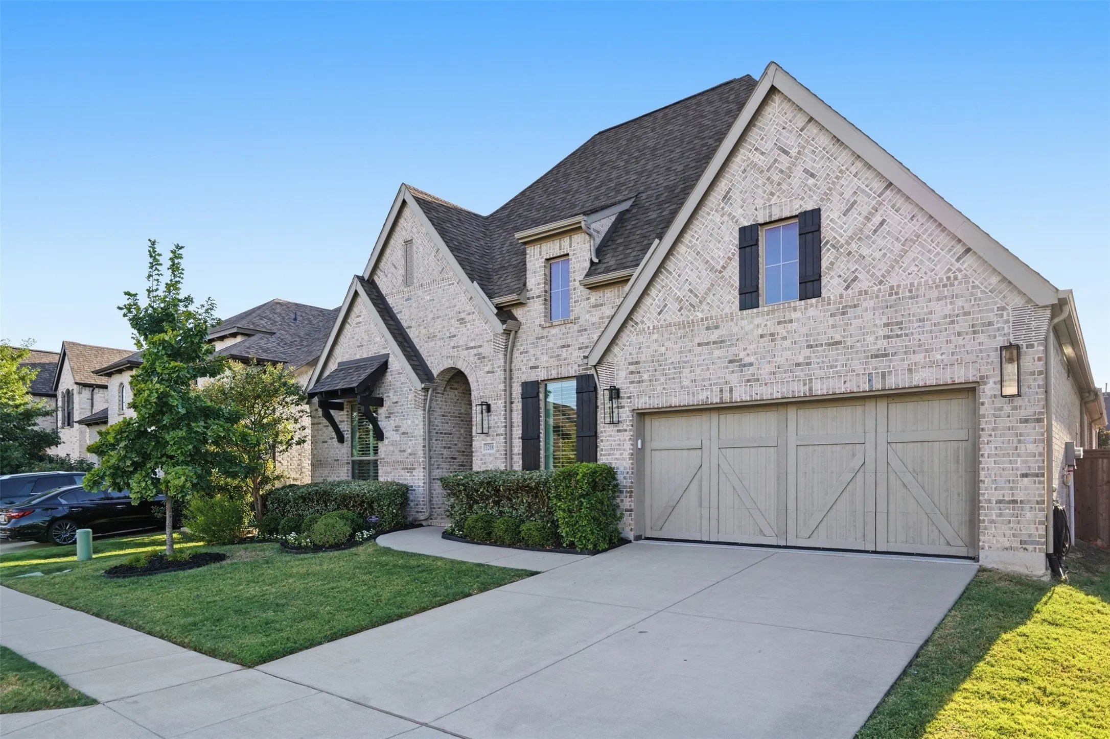 Brick exterior with gabled roof lines, featuring a multi-pane window with dark shutters