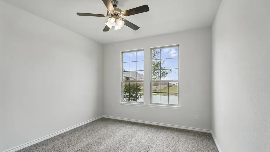 Neutral wall finishes, dual pane windows, and a ceiling fan with integrated lighting