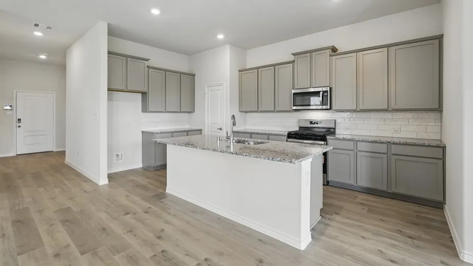 Contemporary kitchen featuring a center island, light gray cabinetry, stainless steel appliances, and wood-finish flooring