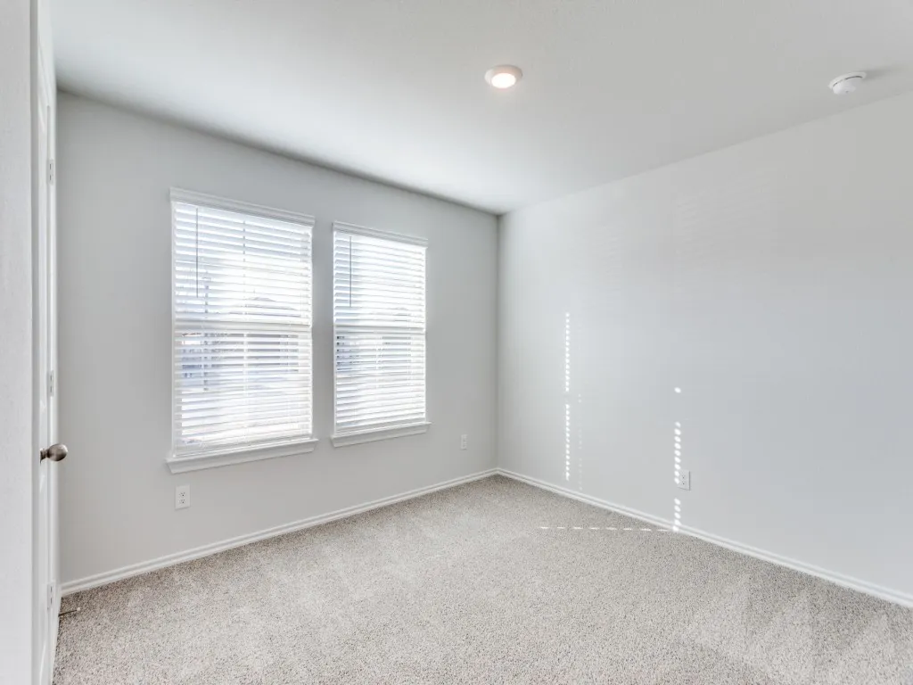 Recessed lighting and two windows with blinds