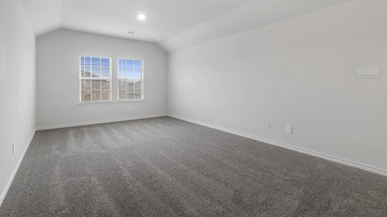 Vaulted ceiling with recessed lighting, wall-to-wall carpeting, and dual windows with blinds