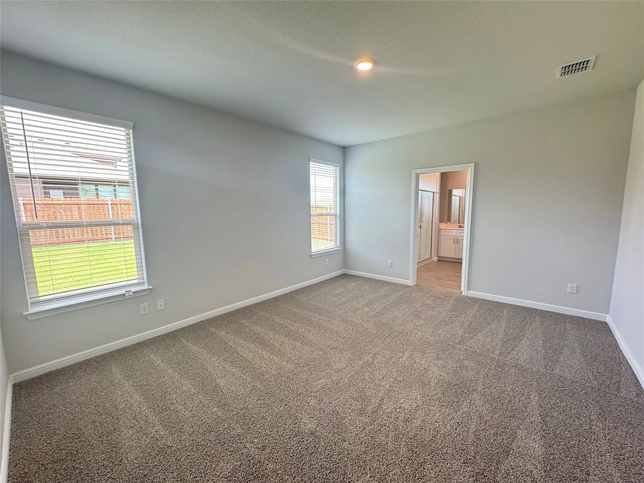 Spare room featuring carpet floors and baseboards