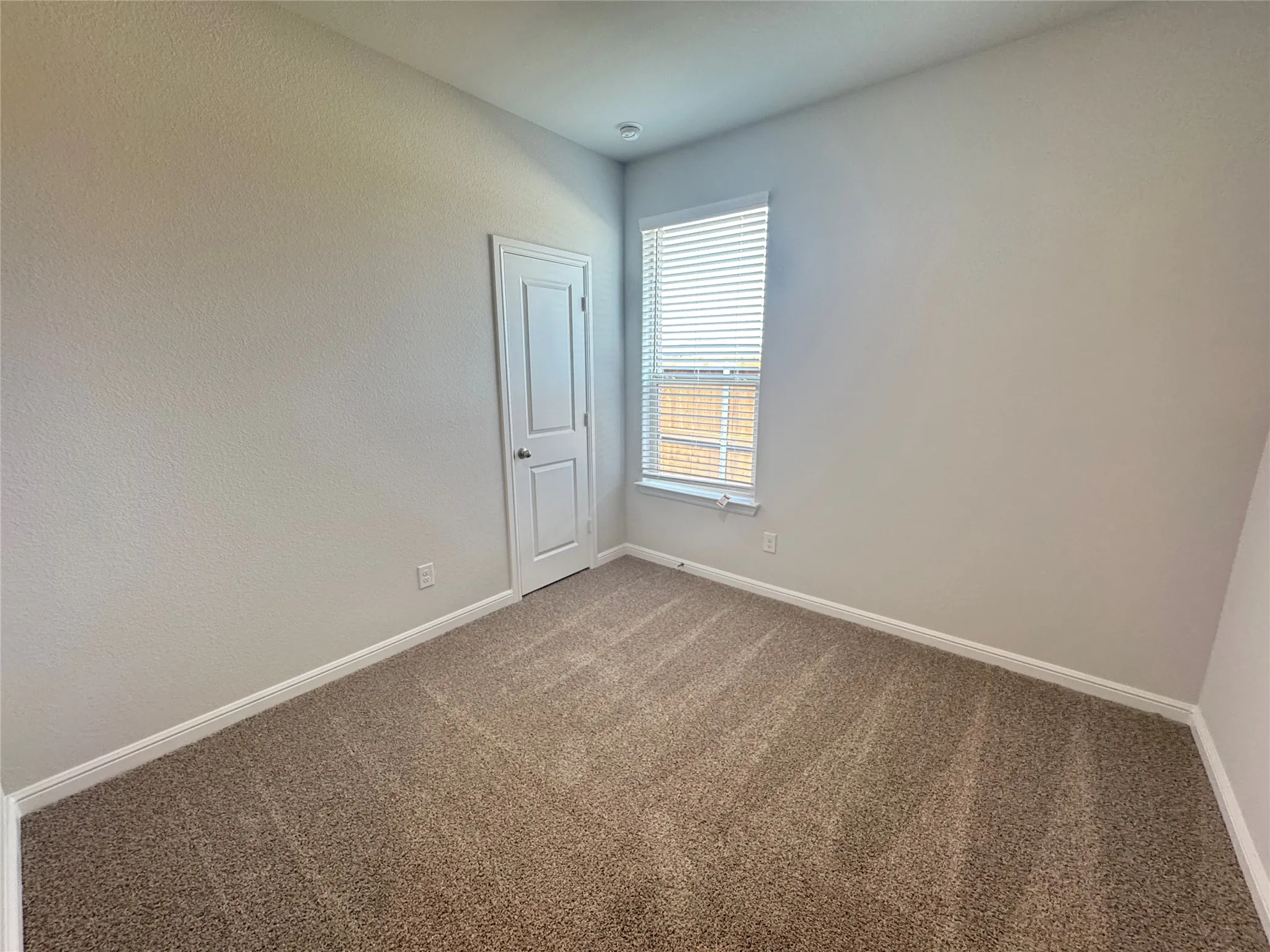 Spare room with carpet flooring and baseboards