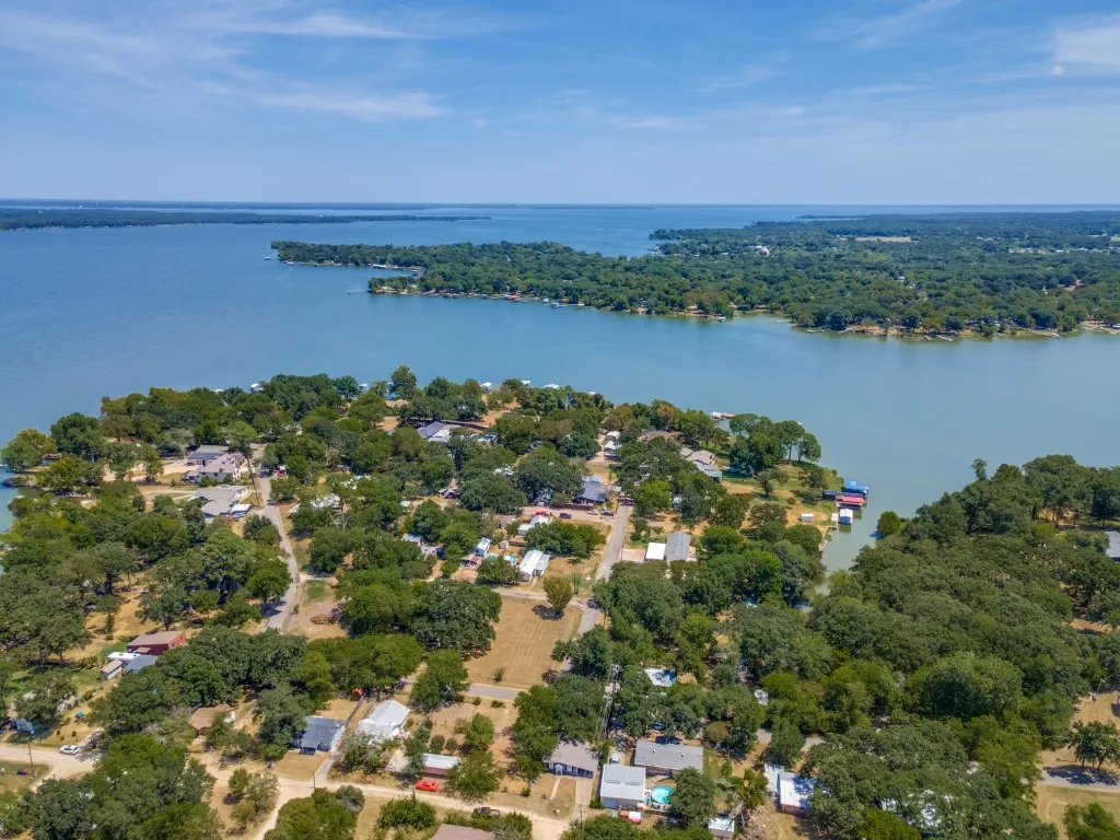 Expansive lakefront setting with mature trees and multiple boat docks