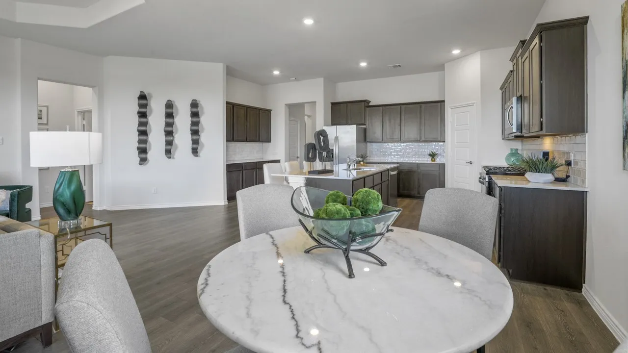 Open concept living area with wood-finish flooring, a tray ceiling, and recessed lighting