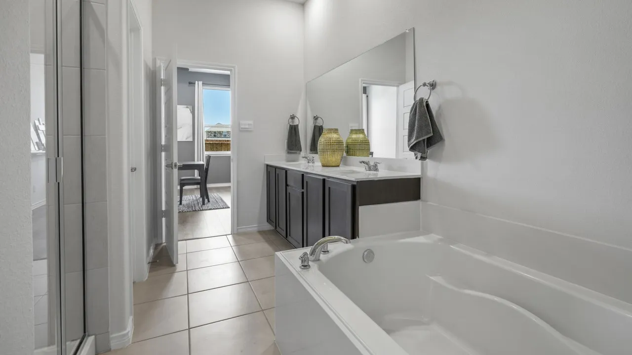 Dual vanity with undermount sinks, white countertop, and expansive mirror