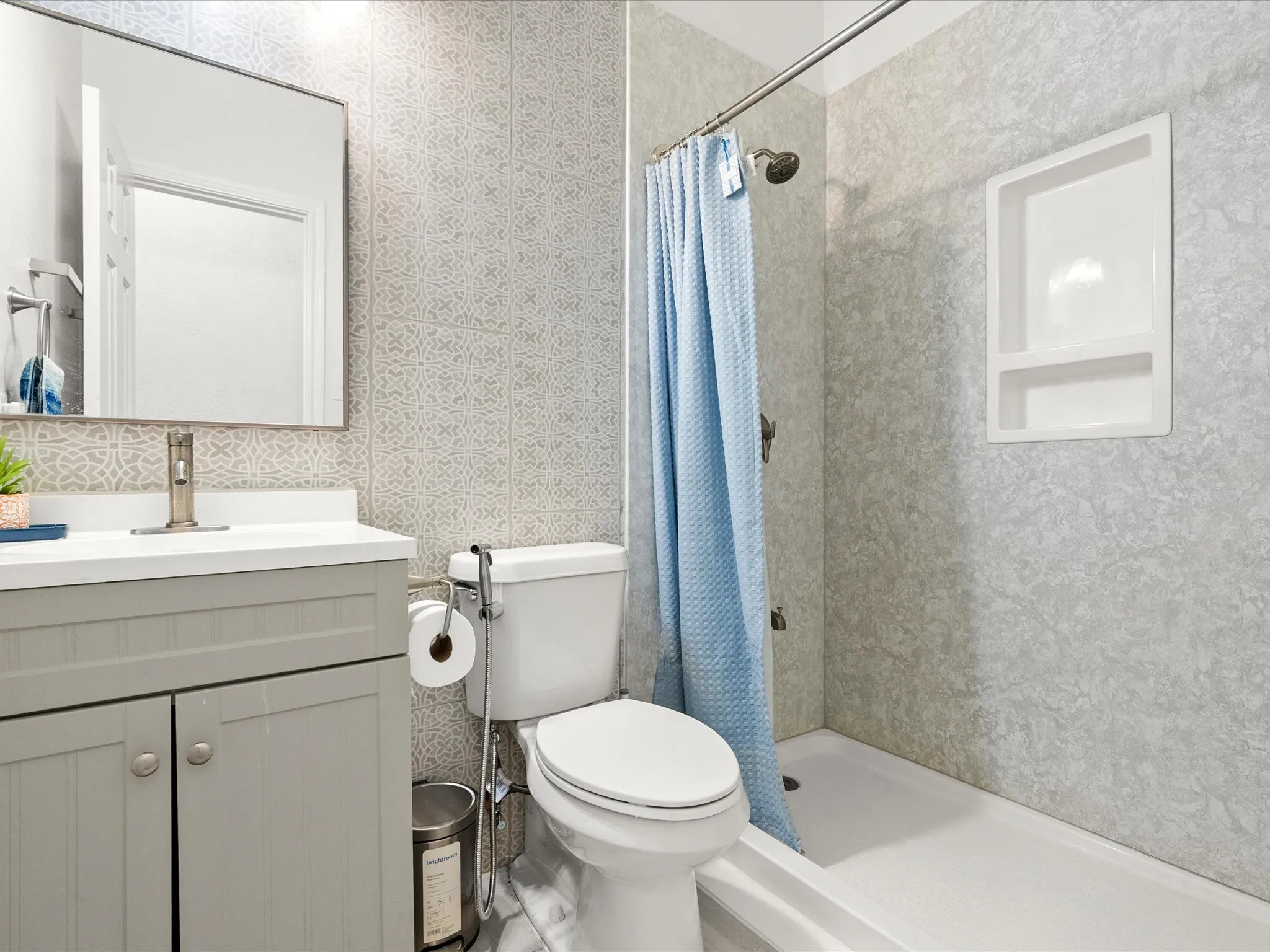 Vanity with white countertop, integrated sink, and brushed nickel faucet
