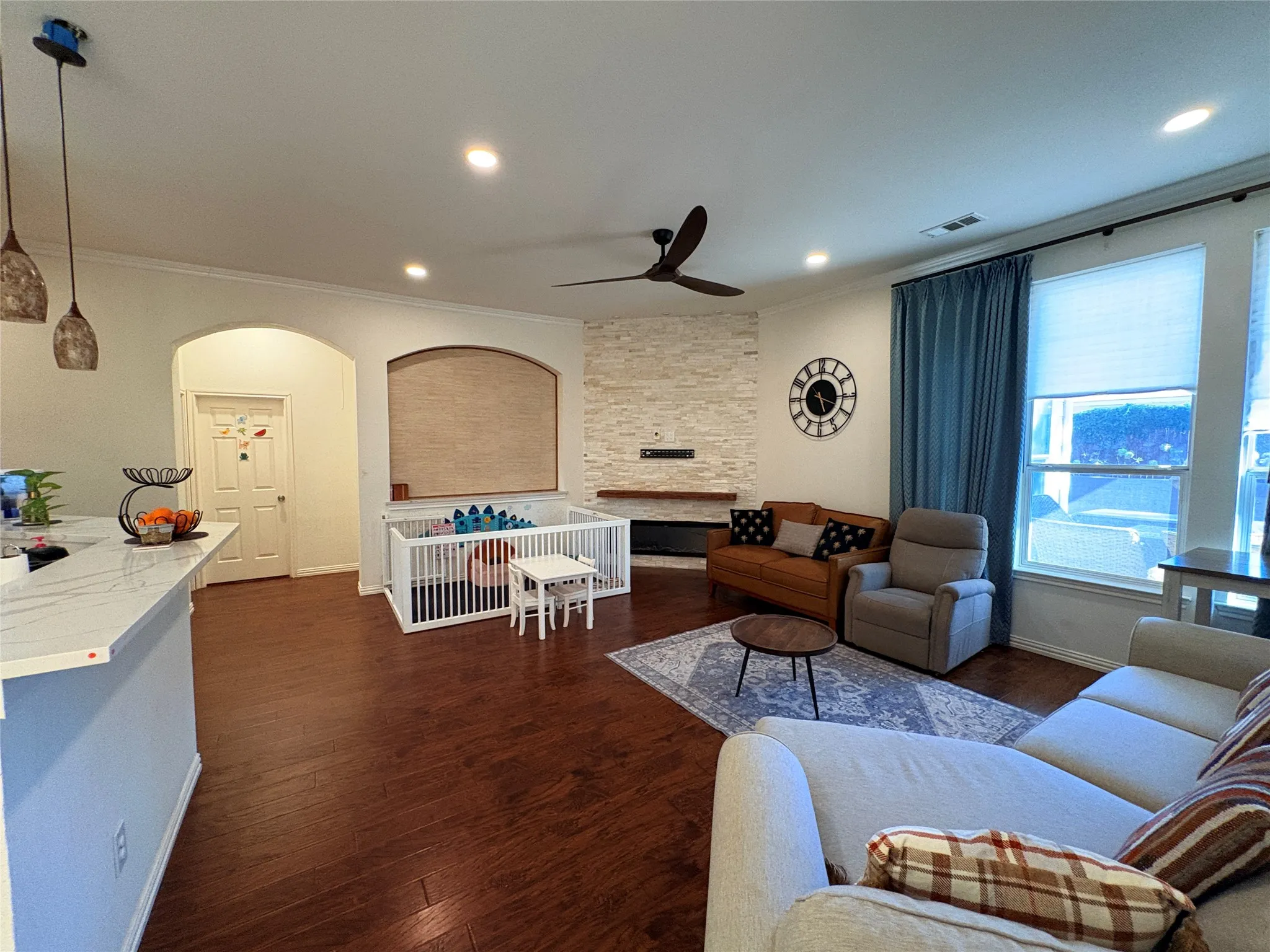 Wood-finish flooring throughout, recessed lighting, and crown molding