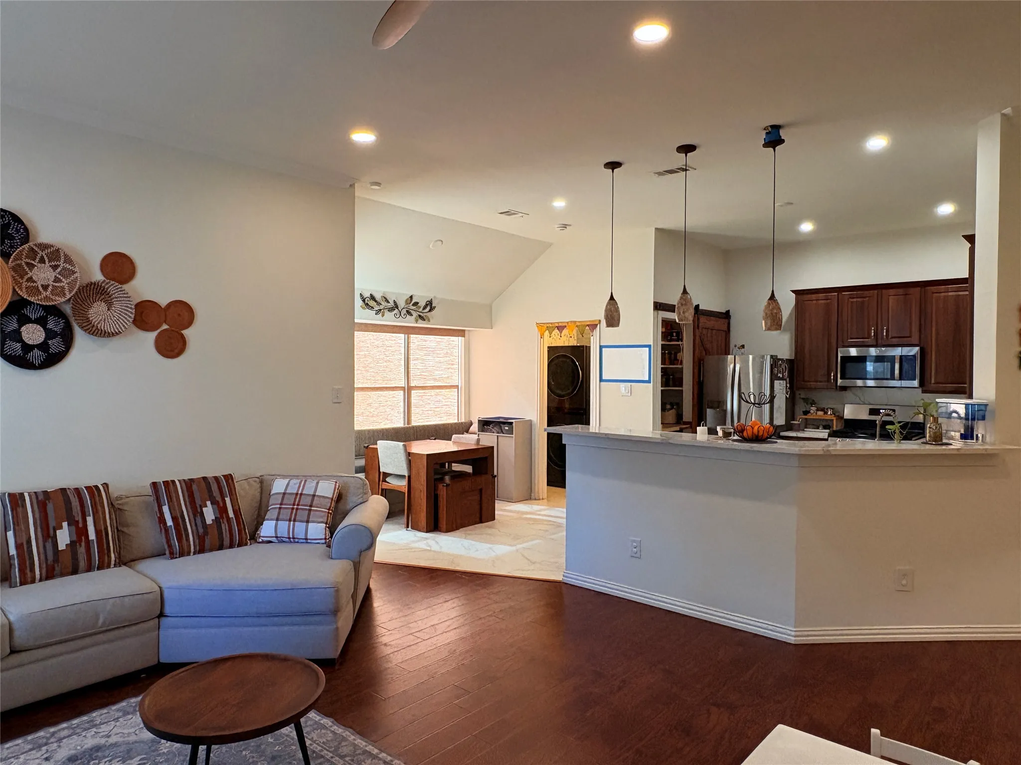 Wood-finish flooring, recessed lighting, and vaulted ceilings