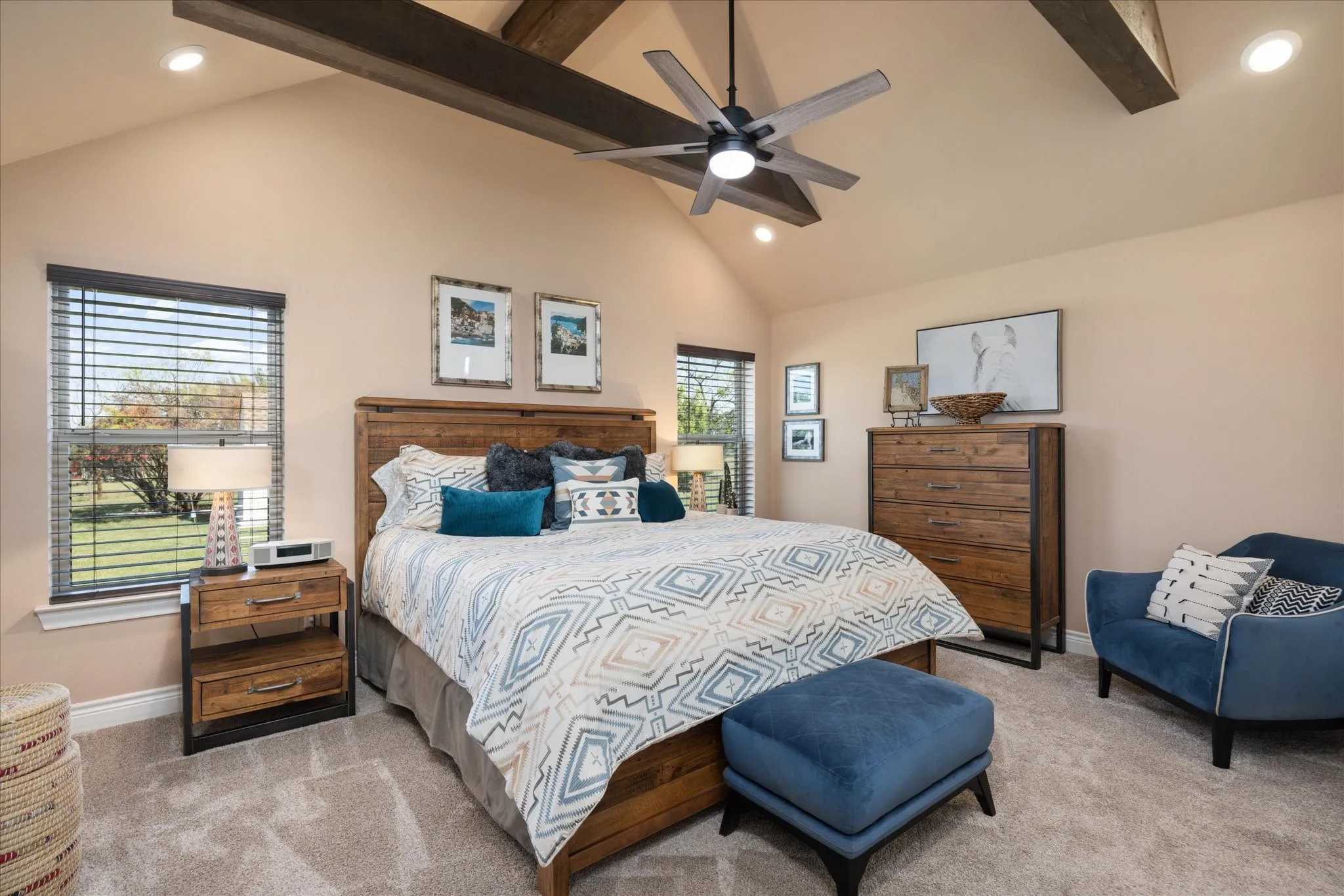 Vaulted ceiling with exposed wood beams, ceiling fan with integrated lighting, recessed lighting, and wall-to-wall carpeting