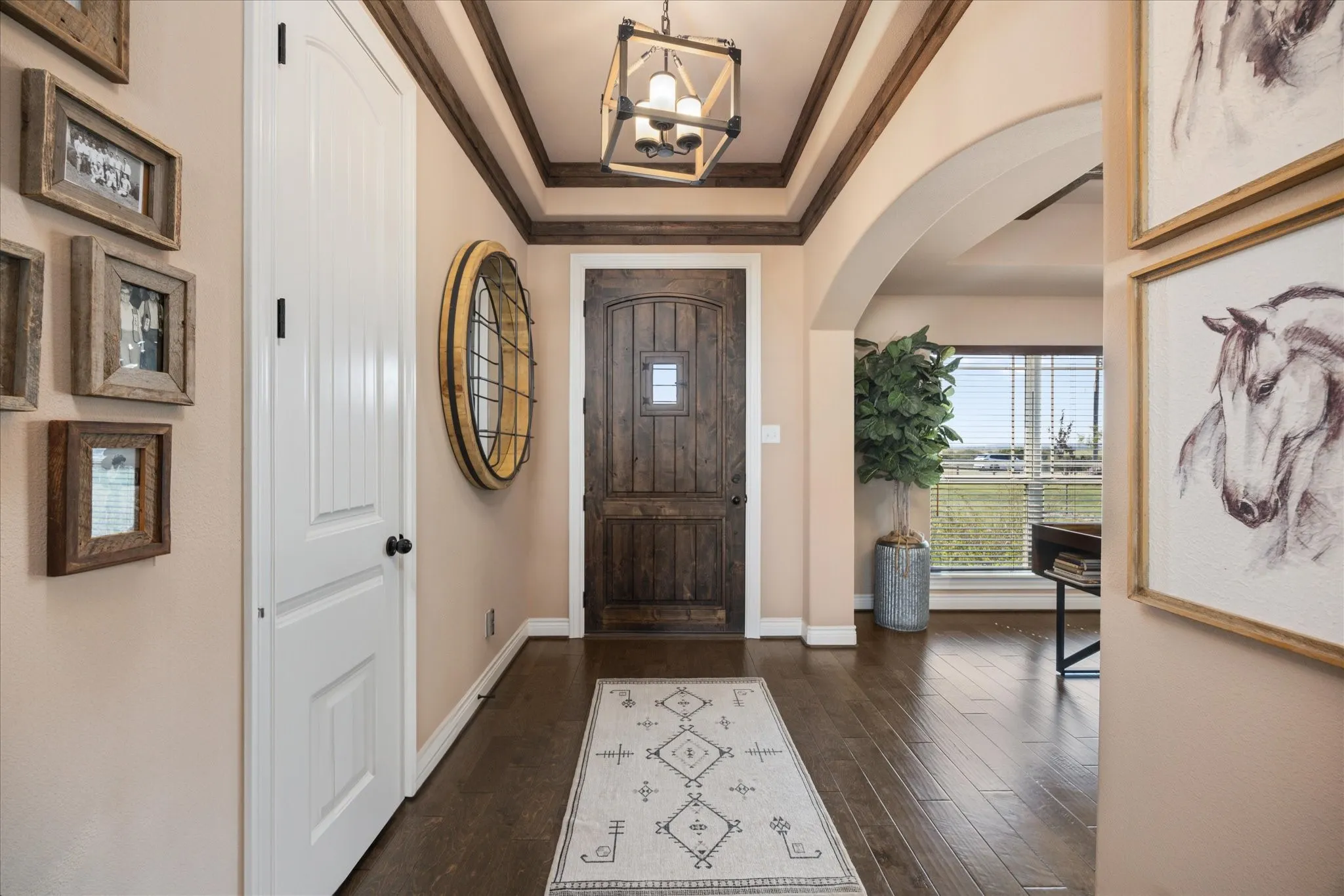 Entryway featuring wood-finish flooring, a coffered ceiling with wood accents, and a distinctive front door with a window insert