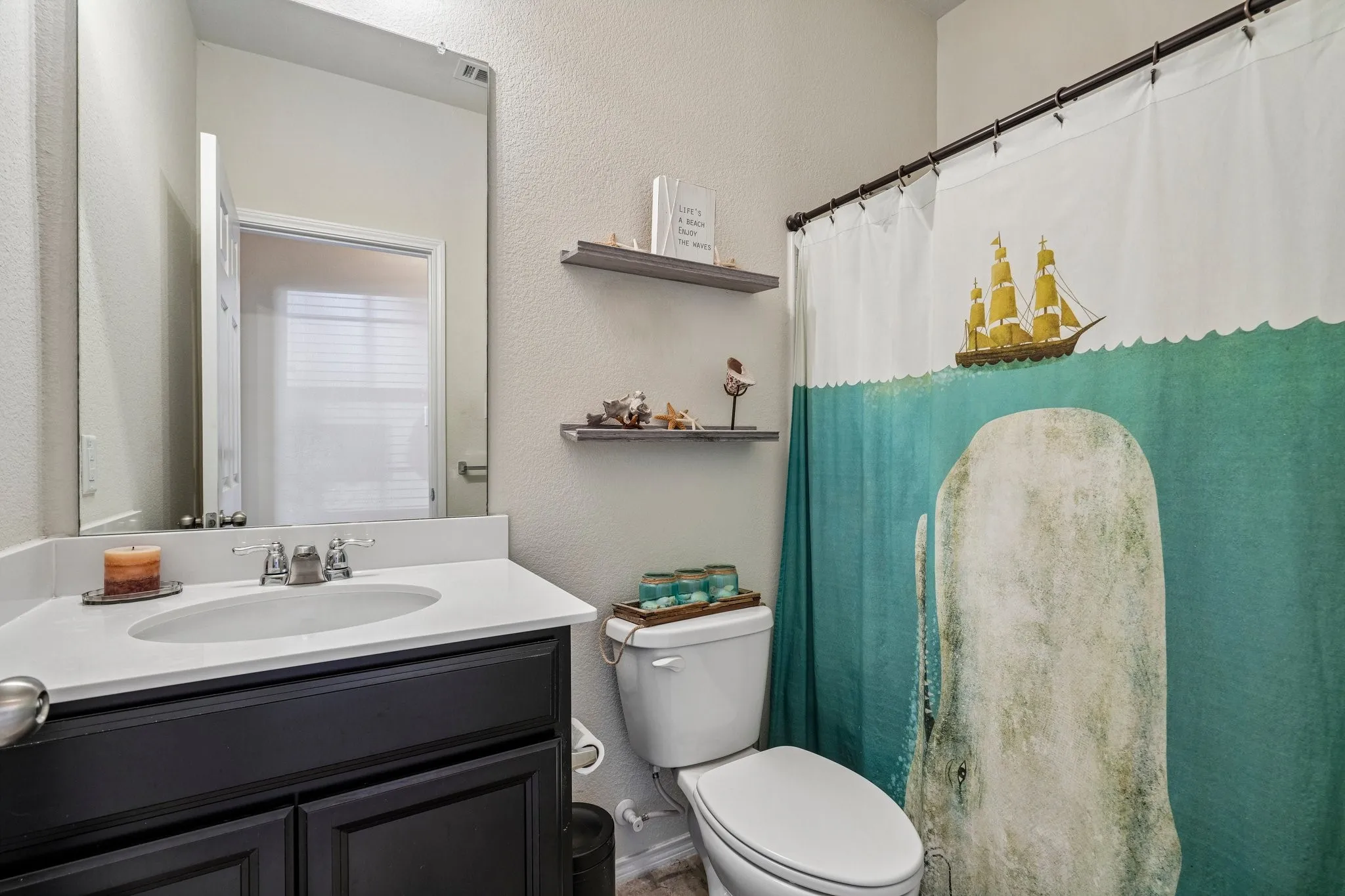 Vanity featuring a white countertop with an integrated sink, dark wood-finish cabinetry, and a chrome-finish faucet
