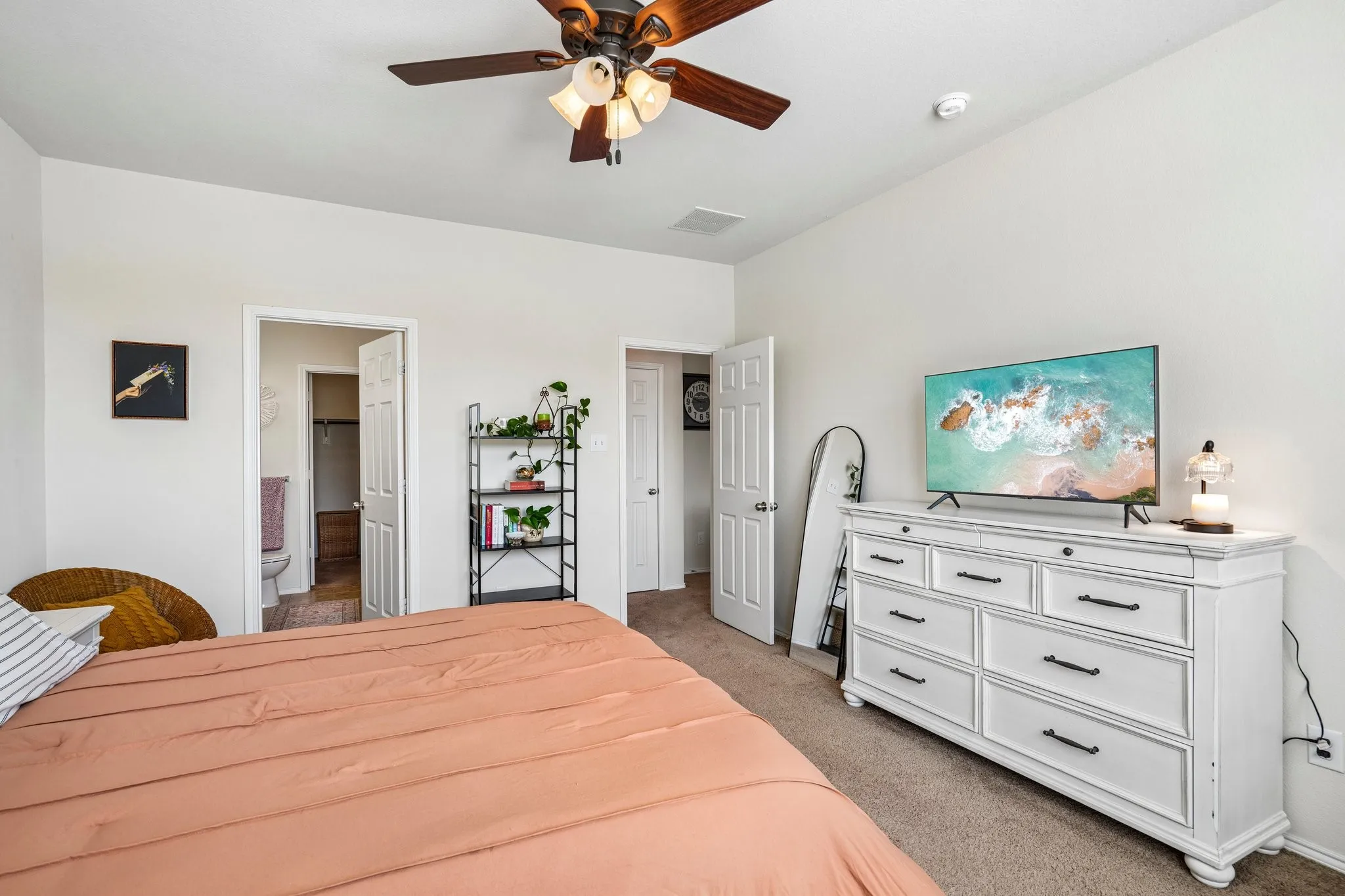 Recessed lighting, ceiling fan, and light-toned carpeting