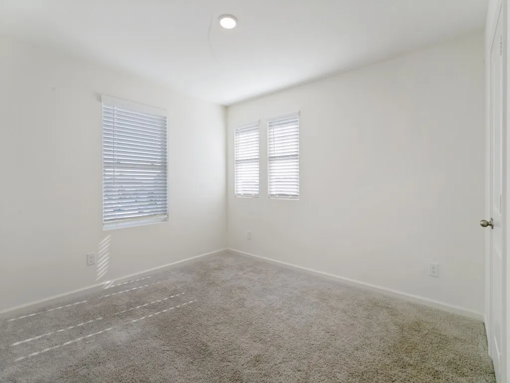 Neutral-toned walls complement the gray carpeting