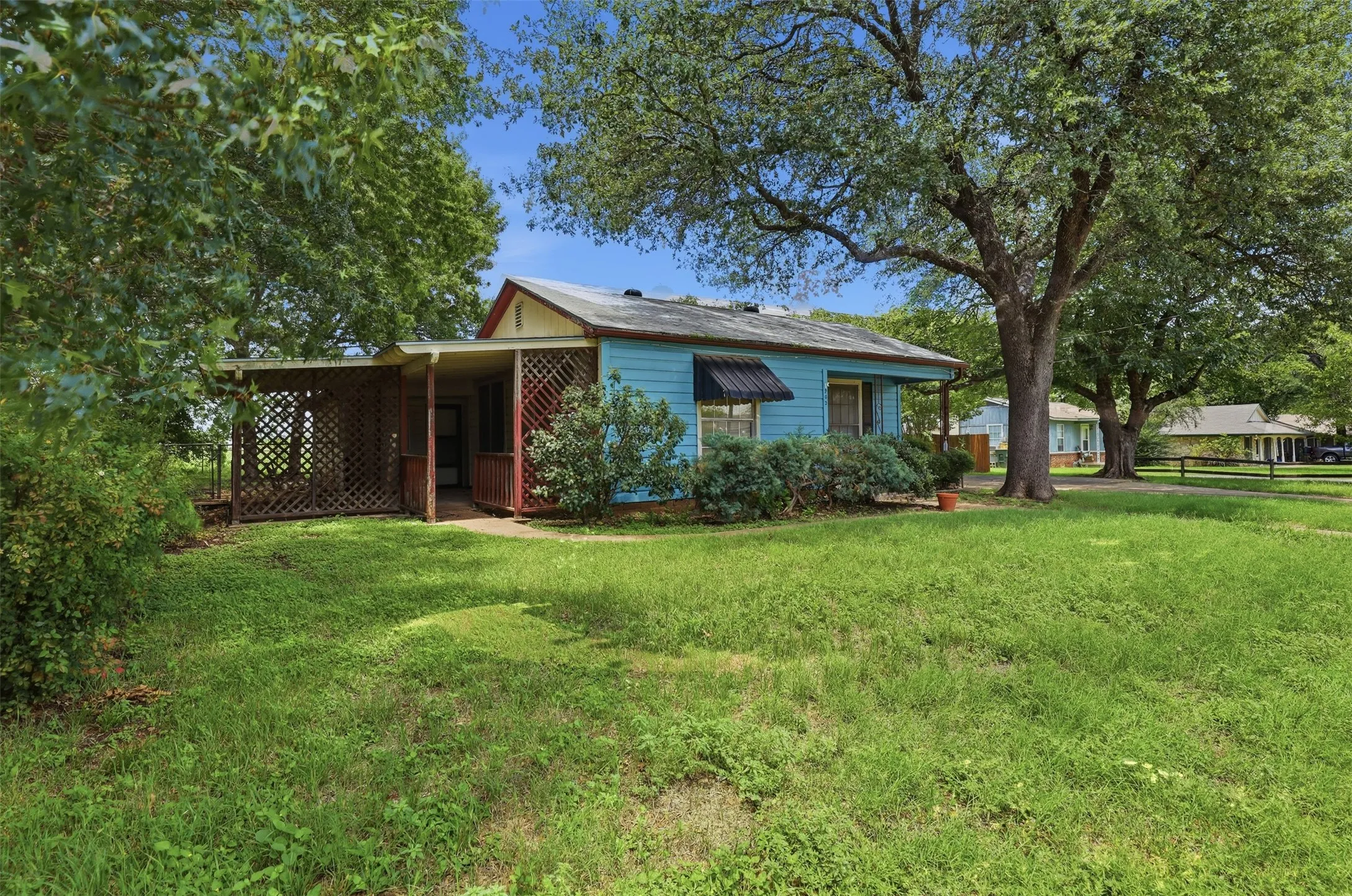 This cute home has a covered side patio.