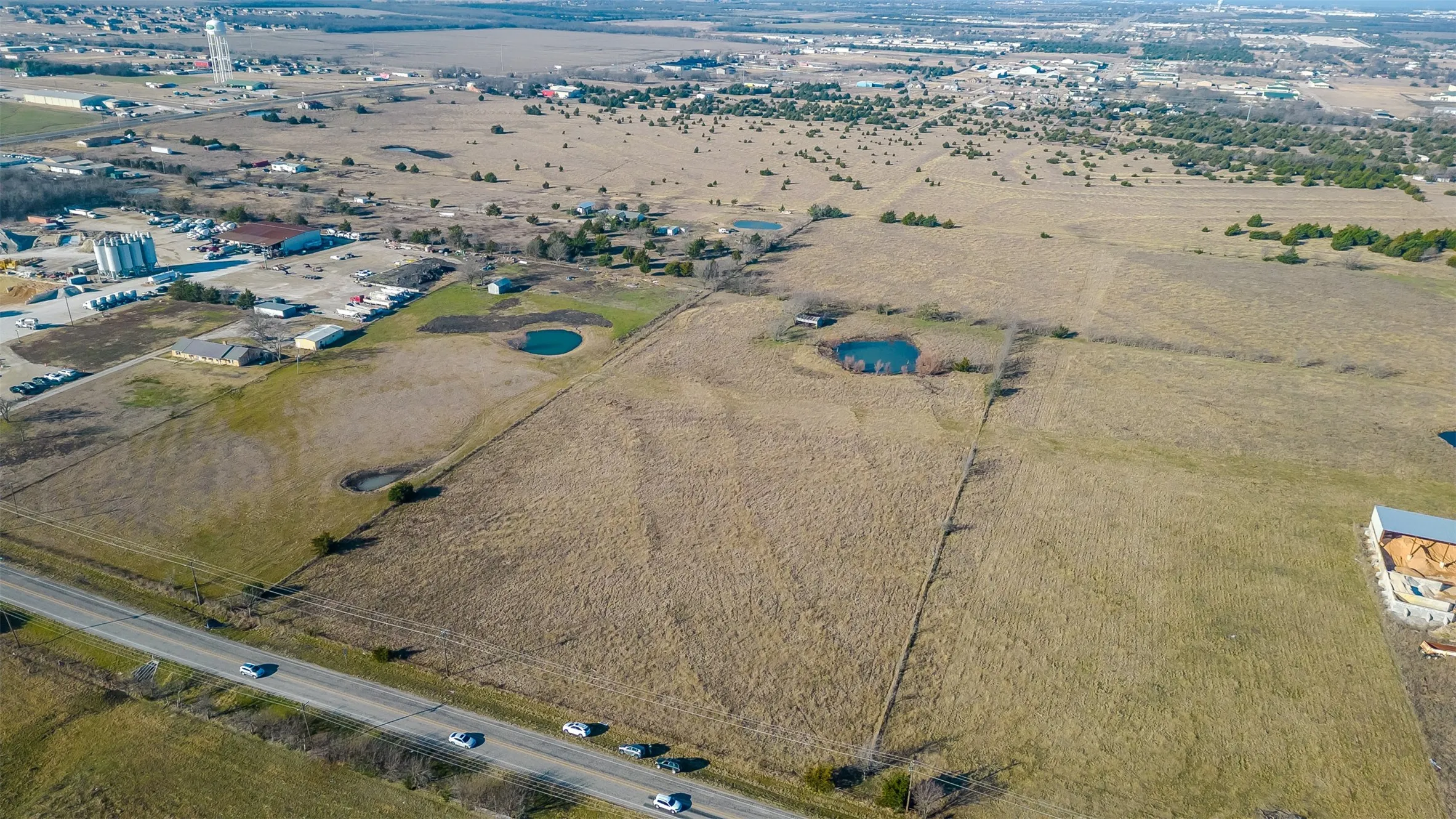 Expansive land parcel featuring two visible a perimeter fence line