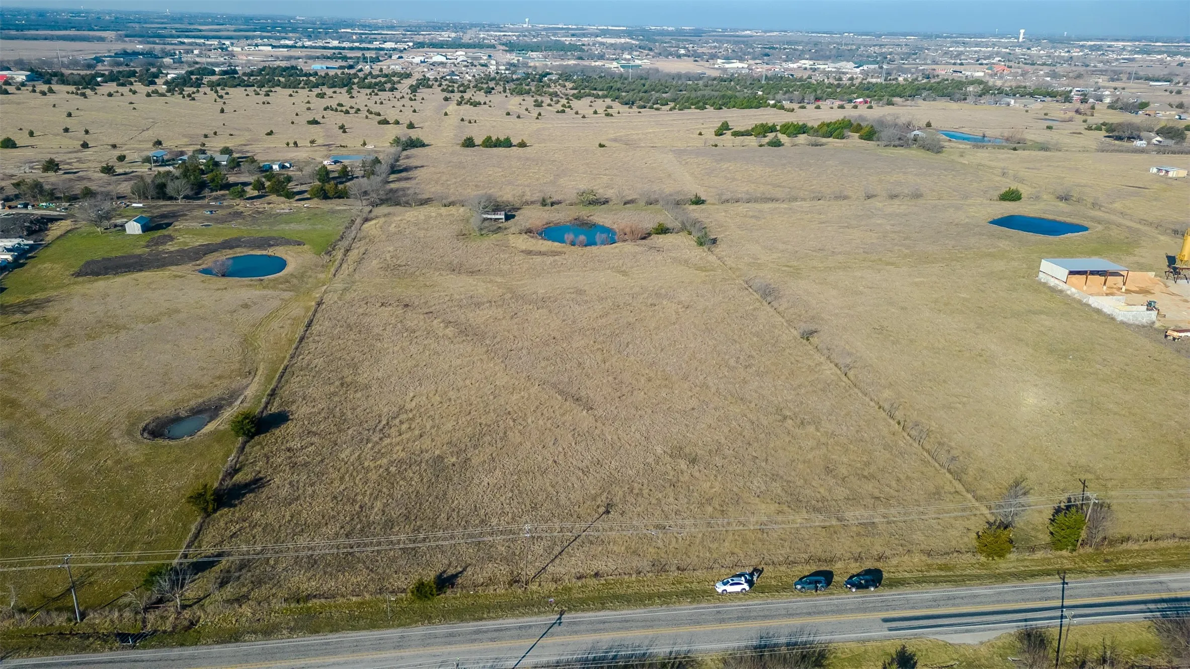 Expansive undeveloped land featuring  a paved road frontage
