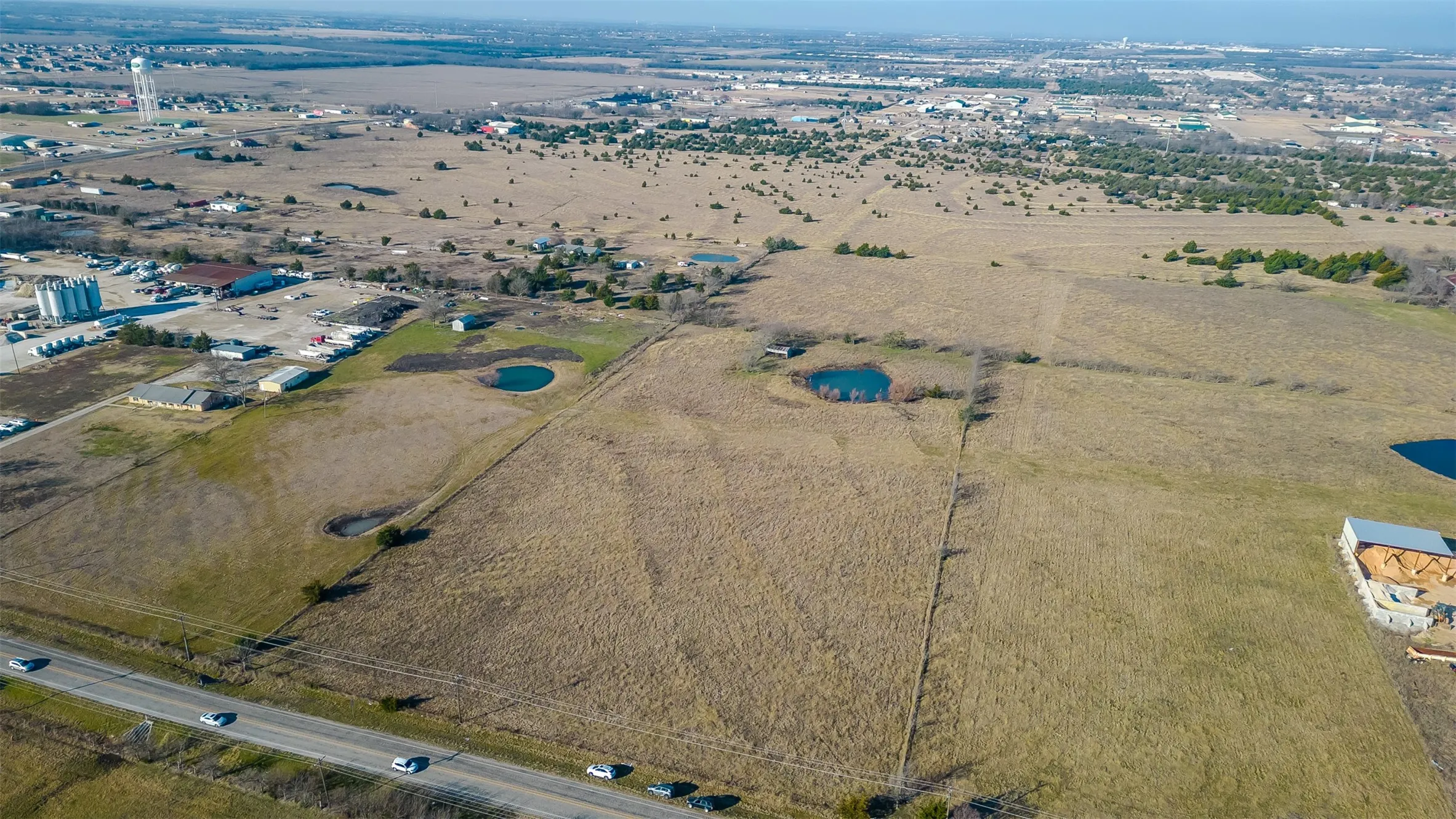 Expansive open land with distant structures