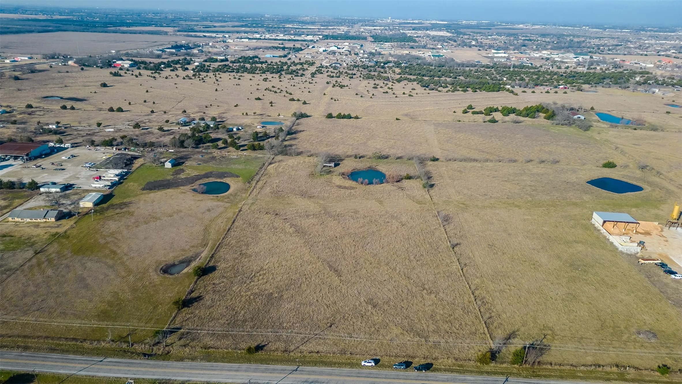 Expansive acreage featuring open fields, and proximity to a paved road