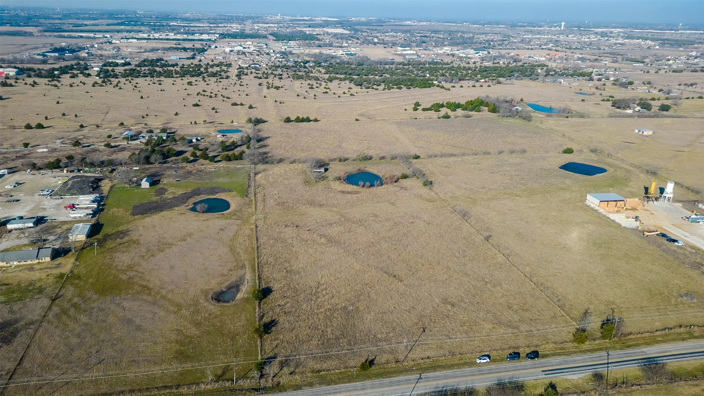 Expansive acreage featuring a distant urban landscape