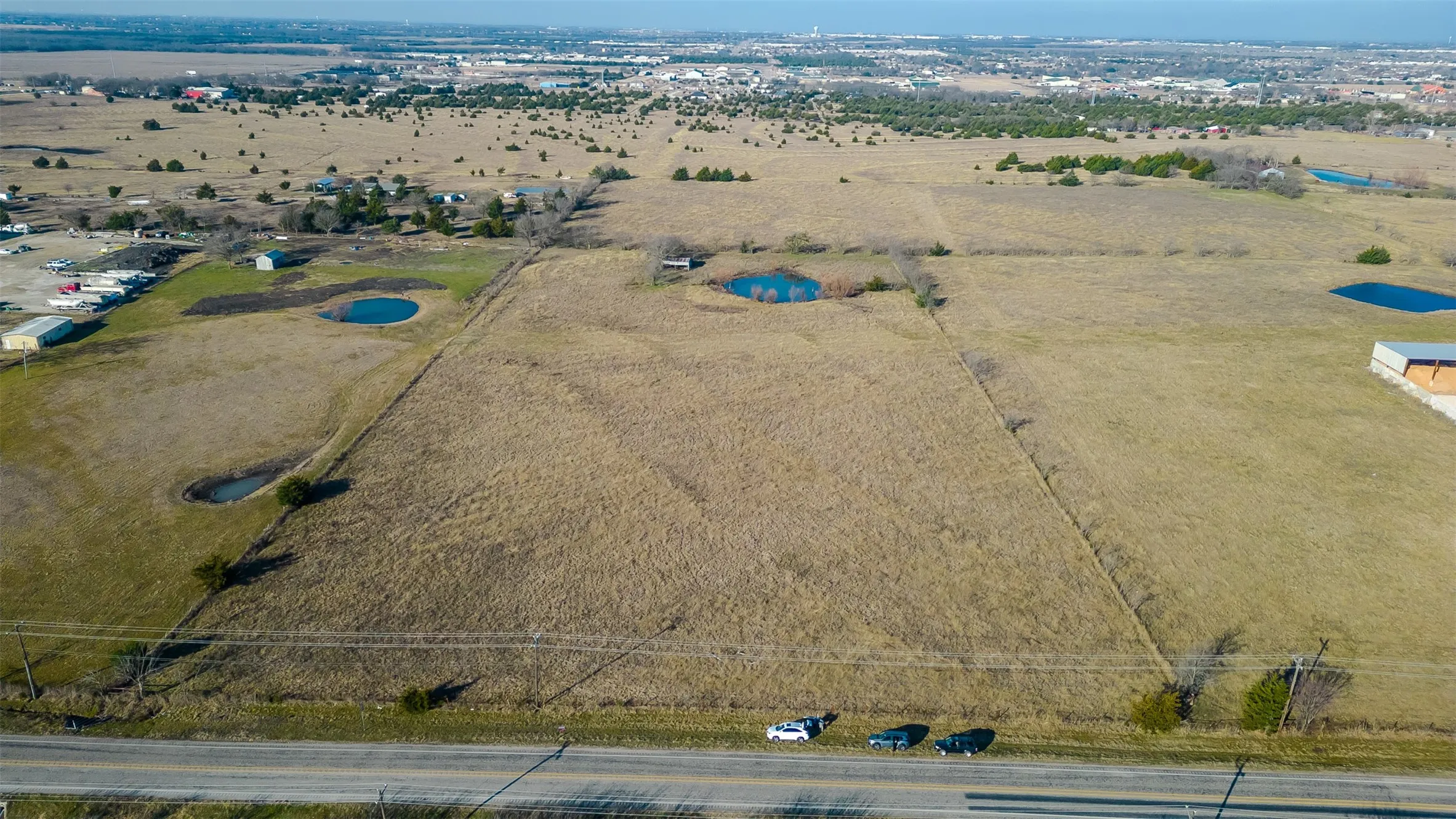 Expansive rural land featuring open fields, and established road frontage