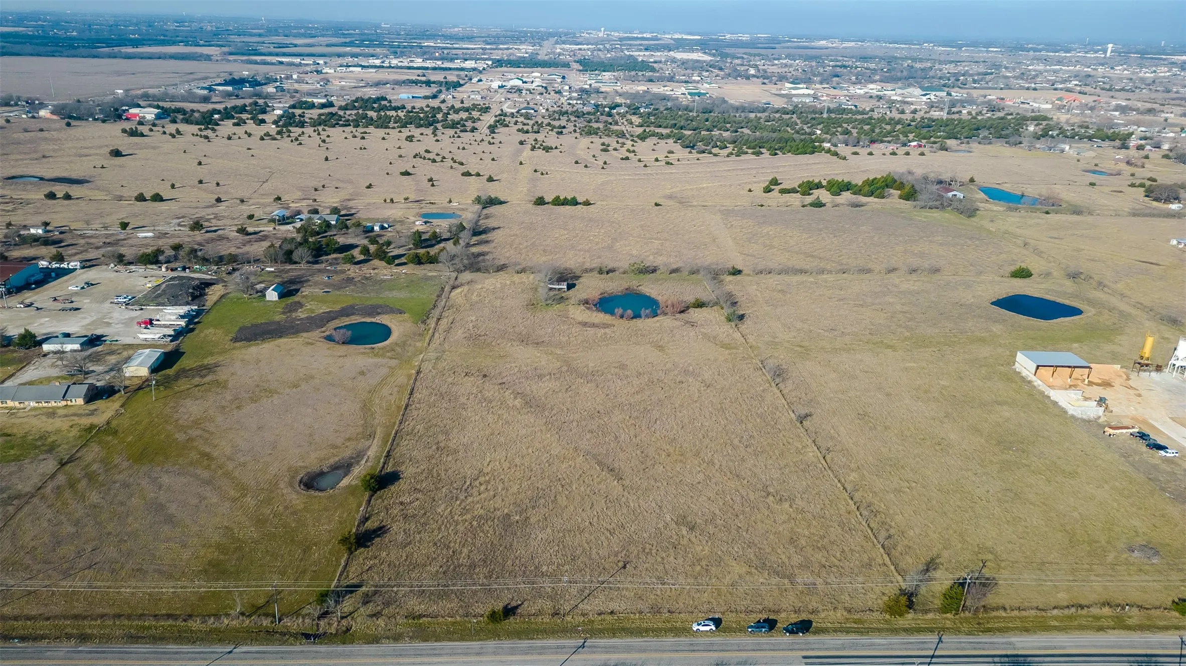 Expansive undeveloped land featuring multiple distinct parcels and natural water features